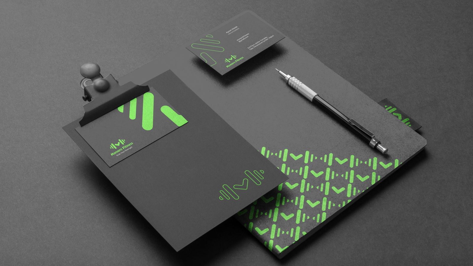 Monarc Fitness stationery flat lay — letterhead and business card